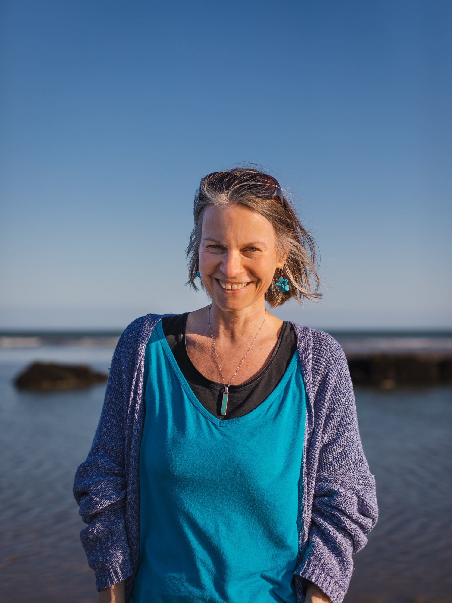 Portrait of Nicky Torode smiling on the shoreline